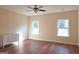 Simple bedroom with hardwood floors, ceiling fan, and dresser at 321 Seventh Ave, Scottdale, GA 30079