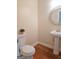 Powder room with pedestal sink, decorative mirror, and hardwood floor at 321 Seventh Ave, Scottdale, GA 30079