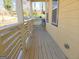 Wooden front porch with railing and seating at 321 Seventh Ave, Scottdale, GA 30079