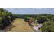 Aerial view of house, yard, and surrounding woodlands at 1092 Harbins Rd, Dacula, GA 30019