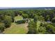Aerial view showing house nestled in a wooded area at 1092 Harbins Rd, Dacula, GA 30019