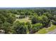 Aerial view of house and expansive property with lush trees at 1092 Harbins Rd, Dacula, GA 30019