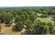 Aerial view of property with home nestled amongst trees at 1072 Harbins Rd, Dacula, GA 30019