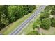 Aerial view of a road adjacent to a wooded area at 1072 Harbins Rd, Dacula, GA 30019
