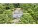 Aerial view of house and surrounding area showing large lot and trees at 1072 Harbins Rd, Dacula, GA 30019