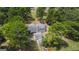Aerial view of house, detached garage, and surrounding trees at 1072 Harbins Rd, Dacula, GA 30019