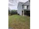 Side view of two-story house with gray siding and fenced yard at 25 Franklin Way, Covington, GA 30016