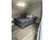 Primary bedroom with gray walls, wood-look flooring, and a king-size bed at 25 Franklin Way, Covington, GA 30016