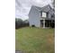 Side view of a gray two-story house with fenced backyard at 25 Franklin Way, Covington, GA 30016