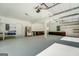 Attached garage with workshop, shelving, and refrigerator at 371 Oakland Rd, Mcdonough, GA 30253