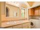 Bathroom with double vanity, stained glass window, and built-in cabinets at 371 Oakland Rd, Mcdonough, GA 30253