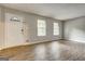 Bright living room featuring wood-look floors, neutral walls, and ample natural light at 5868 Dan Dr, Ellenwood, GA 30294