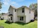 Two-story house with light-colored siding, multiple windows, and a grassy yard at 3752 Arminto Dr, Ellenwood, GA 30294