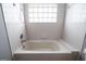 Clean bathroom with a bathtub, shower, and a window at 389 Ralph Mcgill Ne Blvd # E, Atlanta, GA 30312