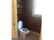 Small bathroom with toilet and patterned wallpaper at 1145 Lake Stone Lea Dr, Oxford, GA 30054