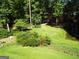 Landscaped backyard with pond and lush greenery at 1145 Lake Stone Lea Dr, Oxford, GA 30054