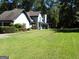 Ranch-style home with well-manicured lawn at 1145 Lake Stone Lea Dr, Oxford, GA 30054