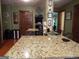 Large kitchen island with granite countertop and cooktop at 1145 Lake Stone Lea Dr, Oxford, GA 30054