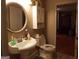 Small bathroom with pedestal sink and white toilet at 1145 Lake Stone Lea Dr, Oxford, GA 30054