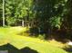 Landscaped backyard with a serene pond feature at 1145 Lake Stone Lea Dr, Oxford, GA 30054