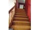 Carpeted staircase with wooden railing leading to upper level at 1145 Lake Stone Lea Dr, Oxford, GA 30054