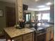 Island kitchen features granite countertops and stainless steel appliances at 1145 Lake Stone Lea Dr, Oxford, GA 30054