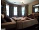 Primary bedroom with bay window and patterned bedding at 1145 Lake Stone Lea Dr, Oxford, GA 30054