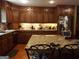 Eat-in kitchen with granite island and abundant wood cabinetry at 1145 Lake Stone Lea Dr, Oxford, GA 30054