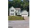 Two story light green house with attached garage at 1950 Wynhurst Xing, Stone Mountain, GA 30088