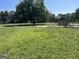 Vacant lot with grassy area, mature trees, and a wooden fence at 175 Moss Dr, Mcdonough, GA 30252