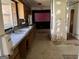 Kitchen features double sink, wood cabinets, and partial wall at 175 Moss Dr, Mcdonough, GA 30252