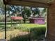 Overgrown backyard with pink shed and covered patio at 175 Moss Dr, Mcdonough, GA 30252