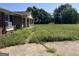 Brick ranch house with overgrown yard and small patio at 175 Moss Dr, Mcdonough, GA 30252