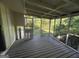 Spacious screened porch with wooden deck and backyard access at 2101 Ann Se Ct, Conyers, GA 30013
