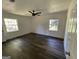 Bedroom with wood-look floors, ceiling fan, and two windows at 2101 Ann Se Ct, Conyers, GA 30013