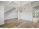 Bright dining room features wood floors, wainscoting, and a stunning chandelier at 125 Leverett Ct, Fayetteville, GA 30215