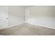 Empty bedroom with carpeted floors and doors at 125 Leverett Ct, Fayetteville, GA 30215