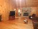Spacious living room with wood walls and stone fireplace at 7505 Hall Rd, Fairburn, GA 30213