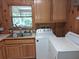 Functional laundry room with washer, dryer, and cabinets at 7505 Hall Rd, Fairburn, GA 30213