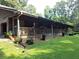 Ranch style home with long front porch and manicured lawn at 7505 Hall Rd, Fairburn, GA 30213