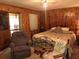 Comfortable main bedroom with wood walls and recliner at 7505 Hall Rd, Fairburn, GA 30213