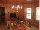 Bright dining area with wood walls and chandelier at 7505 Hall Rd, Fairburn, GA 30213