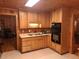 Cozy kitchen with wood cabinets and appliances at 7505 Hall Rd, Fairburn, GA 30213