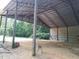 Large metal barn with open sides and dirt floor at 7505 Hall Rd, Fairburn, GA 30213