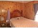 Bedroom with wooden walls and floral bedding at 7505 Hall Rd, Fairburn, GA 30213