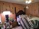 Bedroom with wood paneled walls and plants at 7505 Hall Rd, Fairburn, GA 30213