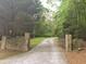 Private gated driveway leading to a wooded property at 7505 Hall Rd, Fairburn, GA 30213