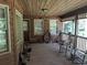 Rustic front porch with wooden rocking chairs and antique decor at 7505 Hall Rd, Fairburn, GA 30213
