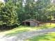 Wooden shed nestled in a lush green wooded area at 7505 Hall Rd, Fairburn, GA 30213