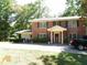 Brick house with a two-car driveway and landscaping at 573 Lester Rd, Fayetteville, GA 30215